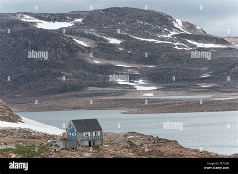 Blue Wooden House Overlooking The Greenland Sea In Autumn