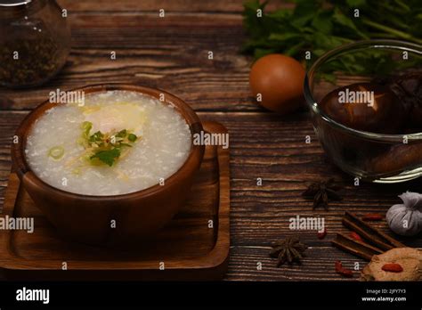 Rice Porridge Rice Gruel Or Congee With Ingredients On Wooden Table