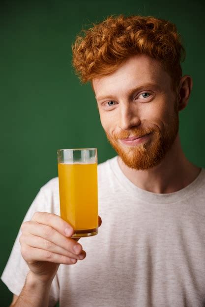 Retrato De Hombre Guapo Con Barba Sonriente Sosteniendo Un Vaso De Jugo