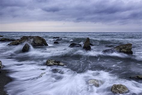 Time Lapse Photography Of Coean Water With Rocks During Daytime Photo