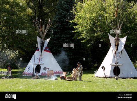 A Native American Indian Tipi Campsite With Men Playing The Drum And