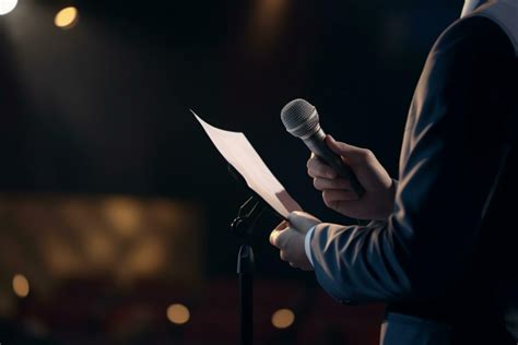 Keynote Speaker On Podium With Script And Microphone In Bright