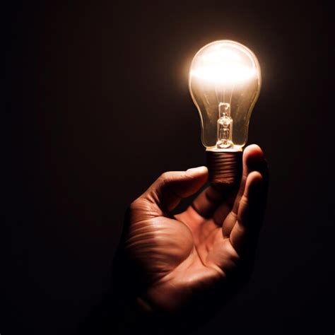 Premium AI Image Photo A Human Hand Hold A Light Bulb