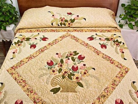 a quilted bed with flowers and leaves on it