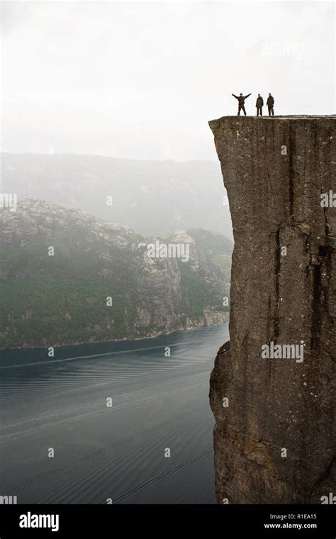 Preikestolen Amazing Rock In Norway Girl Standing On A Cliff Above