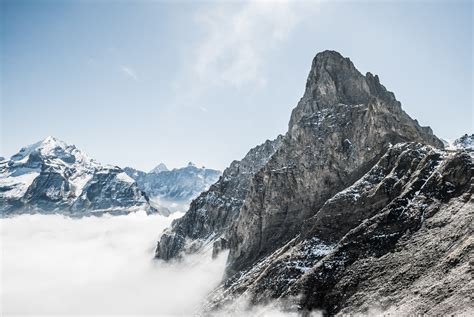 The Snow Covered Bunderspitz Mountain Peak Rising Above The Clouds