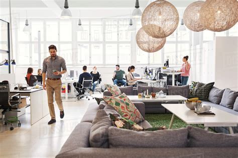 Modern Office Lobby With Business People Working In Background Stock