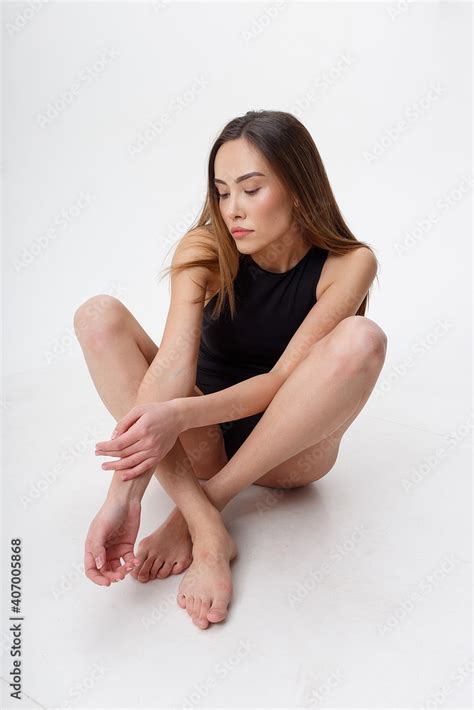 Sexy Asian Woman With Long Hair Posing In Black Lingerie On White Studio Background With Bare