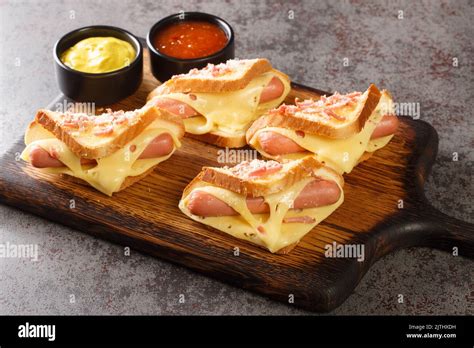 Sandwiches With Egg Sausages And Toast Cheese Fried In A Pan Closeup