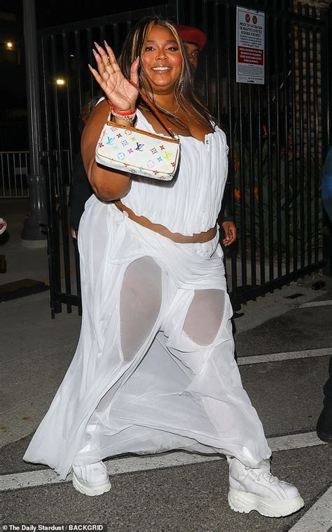 Lizzo Displays Her Curves In A White Corset And Bizarre Sheer Trousers As She Holds Hands With