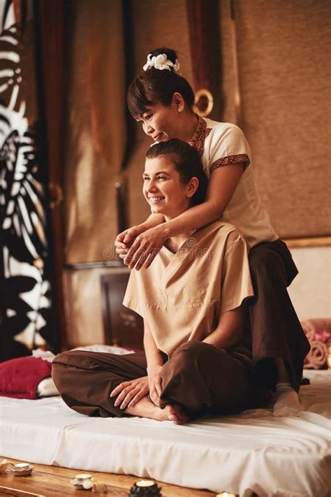 Massagist Pressing On Happy Lady Shoulders During Thai Massage Stock