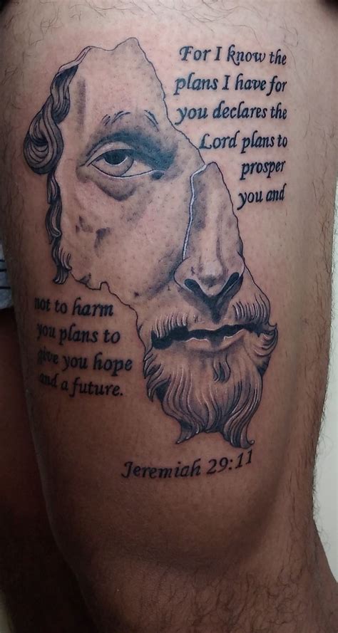 a man's thigh with a bible tattoo on it