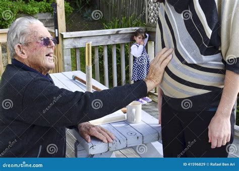 Grandfather Holds His Pregnant Granddaughter Abdomen Stock Image