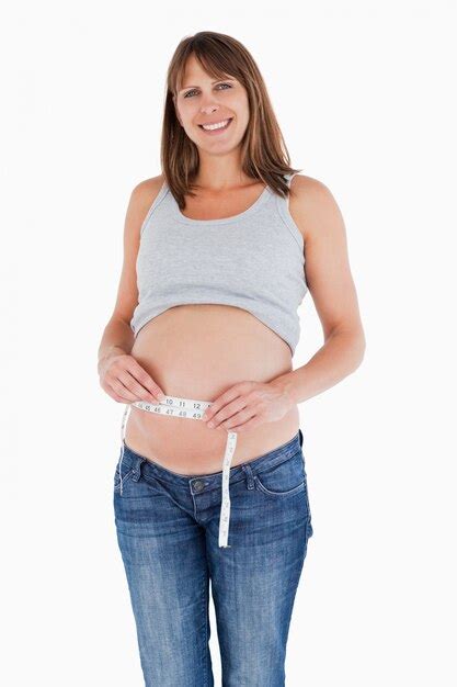 Premium Photo Cute Pregnant Woman Measuring Her Belly While Standing