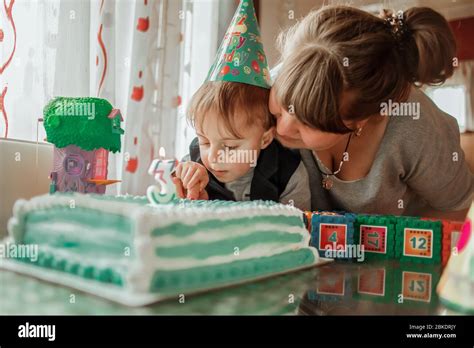 Mother and son celebrate birthday party wiyh cake at home Stock Photo - Alamy