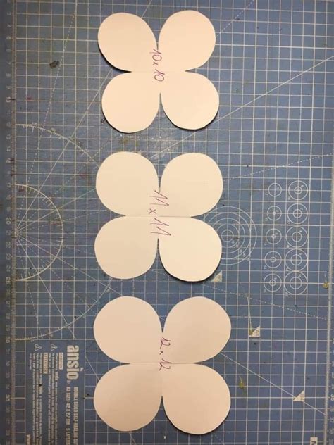 Three Pieces Of Paper Cut Out To Look Like Flowers