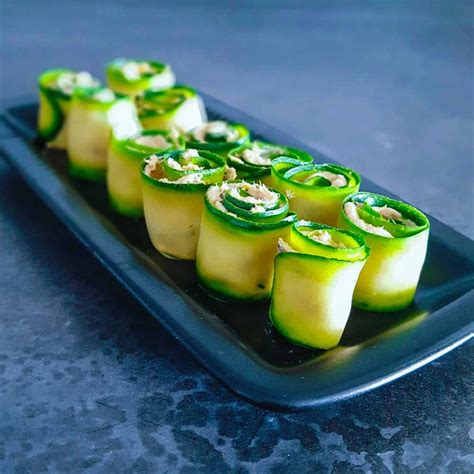 A Black Plate Topped With Sliced Cucumbers On Top Of A Gray Countertop