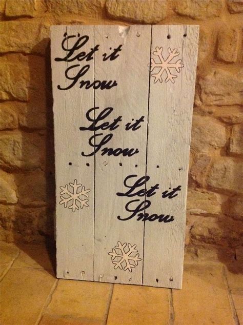 A Wooden Sign That Says Let It Snow