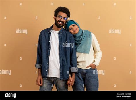 Romantic Young Muslim Couple Holding Hands And Looking At Camera Stock ...