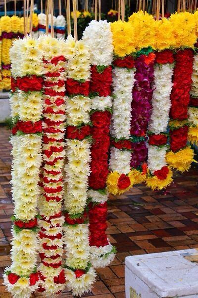 Colorful Flower Garlands Are Hanging From The Ceiling In Front Of A