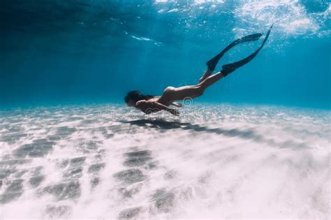 Naked Woman Free Diver Glides Over Sandy Sea With Fins Freediving In