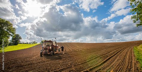 Foto de Agriculteur et son tracteur au milieu d un champ labouré en