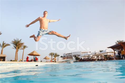 Man Jumping In Swimming Pool Stock Photo Royalty Free Freeimages