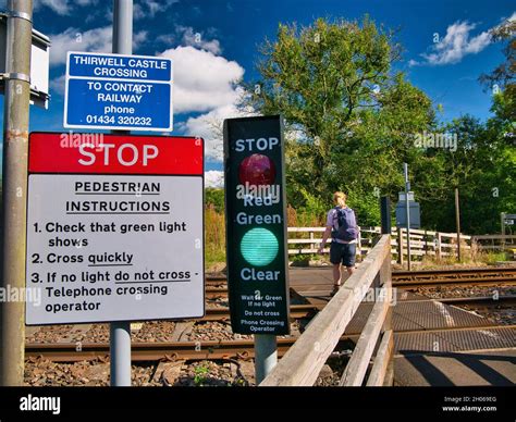 White Red And Blue Signs Warn Those Crossing The Railway To Stop And