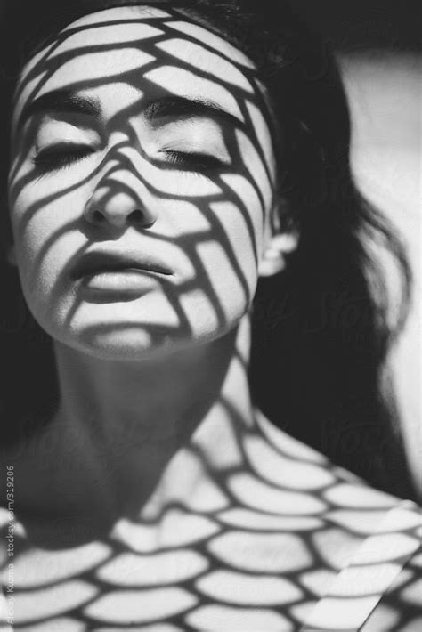 Closeup Of Beautiful Woman With A Geometric Patterned Shadow On Her