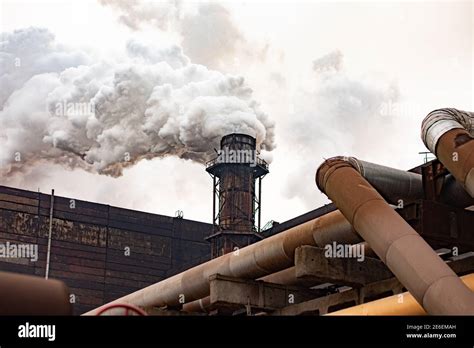 Gran planta metalúrgica industrial en un día nublado El humo pesado de