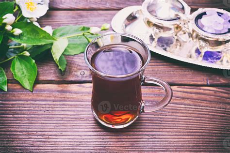 Black tea in a glass transparent glass with a handle 18964837 Stock