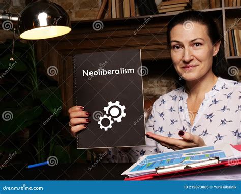 Business Concept About Neoliberalism With Sign On Black Notepad In Hand Stock Image Image Of