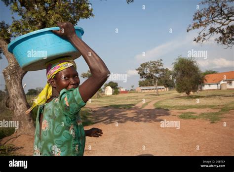 A woman carries water back from a well in Amuria District, Uganda, East ...