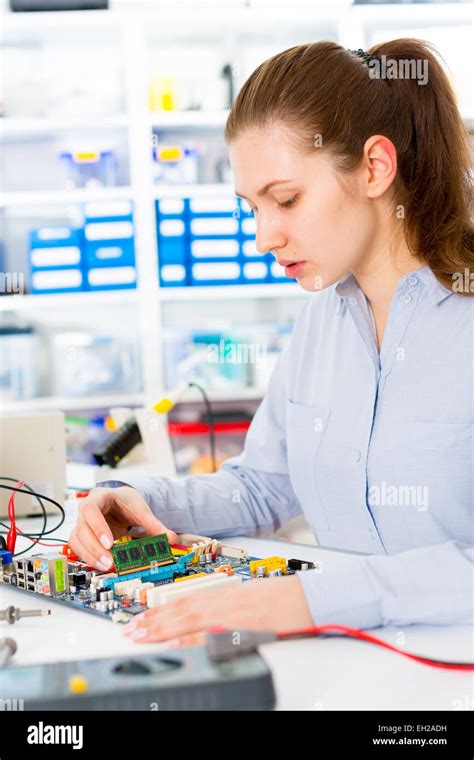 Woman with a tester and a printed circuit board Stock Photo - Alamy