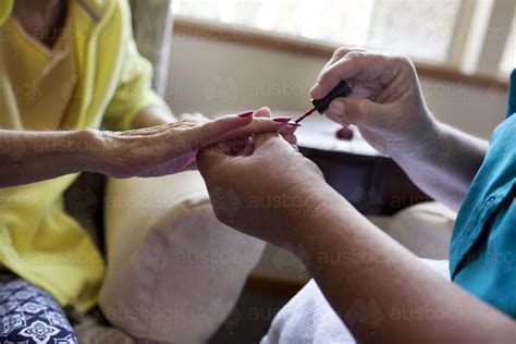 Image Of Elderly Lady Having Nails Painted By Carer At Nursing Home