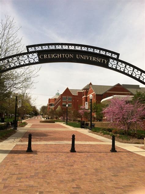 an arch over a brick walkway leading to buildings