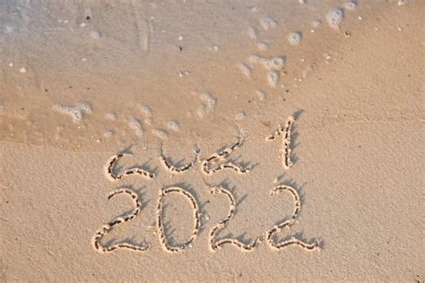 Sea Wave Rolling Onto Sandy Beach With Written And New Year