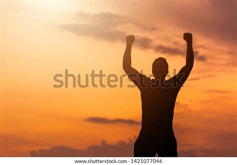 Silhouette Man Hands Raised Sunset Empowered Stock Photo