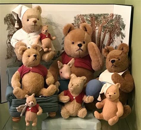 A Group Of Teddy Bears Sitting Next To Each Other On Top Of A Shelf In