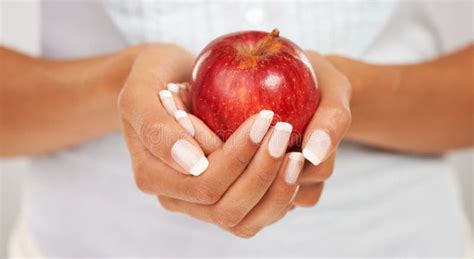 Holding On To Health Closeup Shot Of Hands Holding Out A Fresh Red