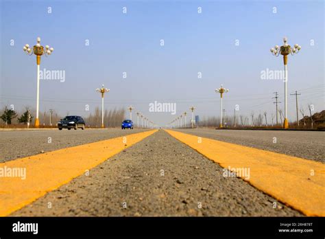 yellow double solid line on the road Stock Photo - Alamy