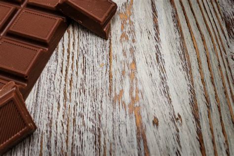 dark chocolate chunks  wooden background closeup stock image image