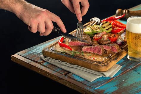 Man Dinner Steak Grilled With Grilled Vegetables And Lager Beer Stock