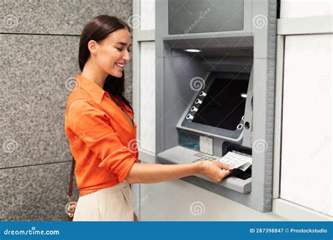 Happy Woman Using Atm Machine Withdrawing Dollar Cash Outdoots Stock