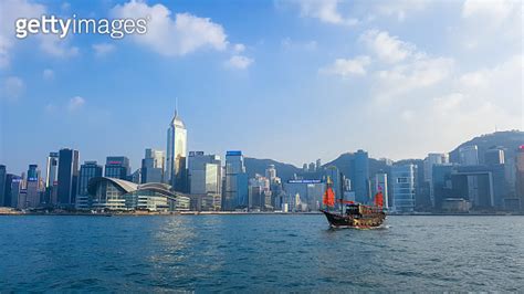 Red Sail Chinese Junk Boats Cruising On Victoria Harbour In Front Of