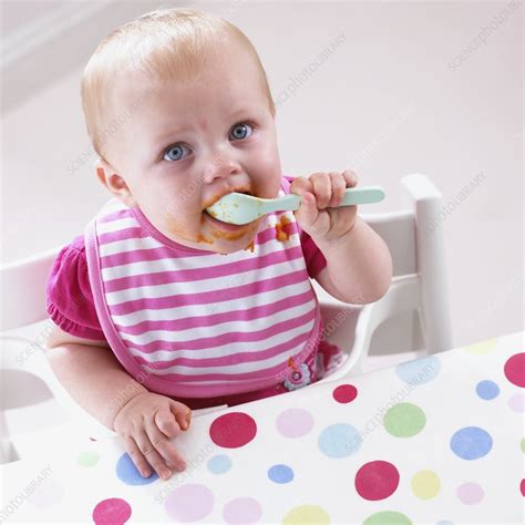 Baby Girl Holding Spoon To Mouth Stock Image C0520154 Science