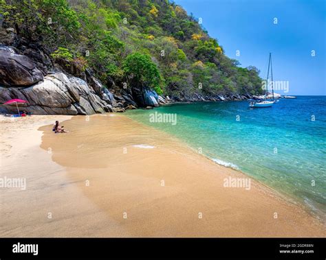 A Couple Enjoys Fresh Coconuts At Colomitos Beach A Hidden Gem Of