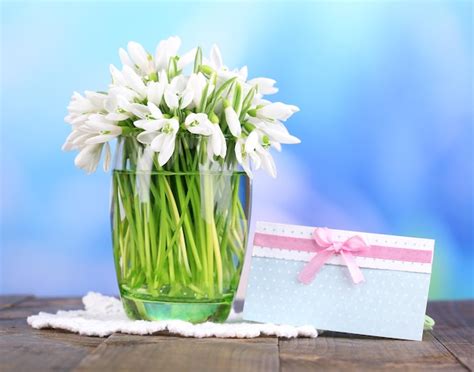 Premium Photo Beautiful Snowdrops In Vase On Wooden Table On Bright