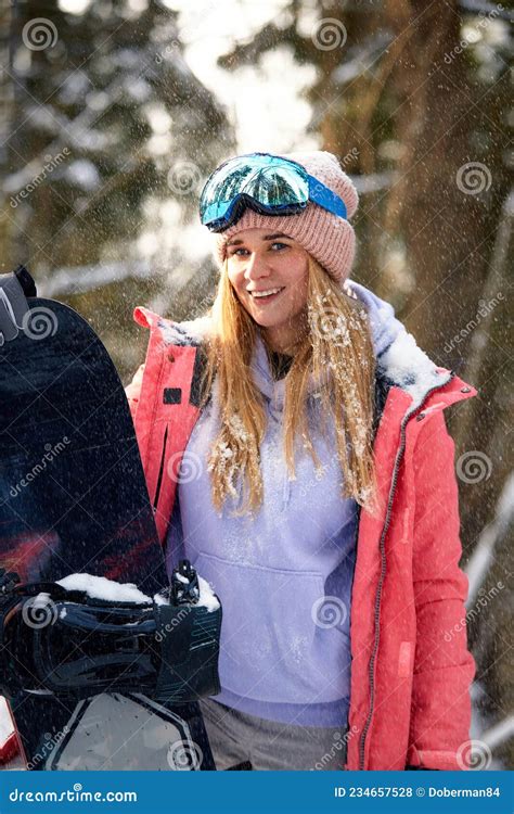 Close Up Portrait Of Snowboarder Woman At Ski Resort Wearing Helmet And