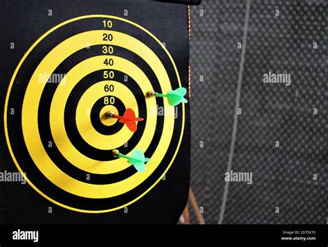 Red Dart Arrow Hitting In The Target Center Of Dartboard With Nice Back